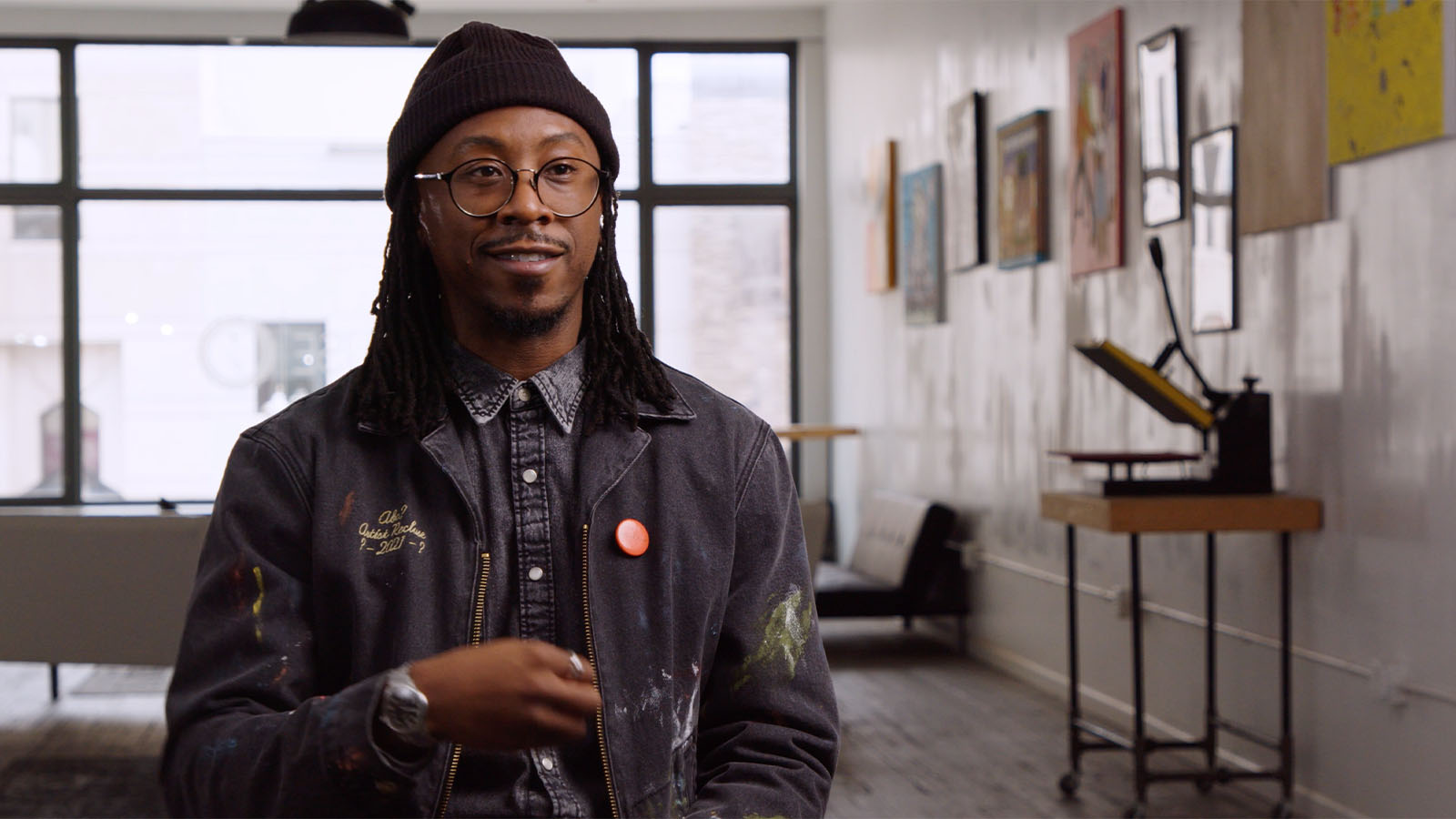 UM-Flint Alum, Lee Grant Allen, talking inside shop and wearing glasses and a knit cap